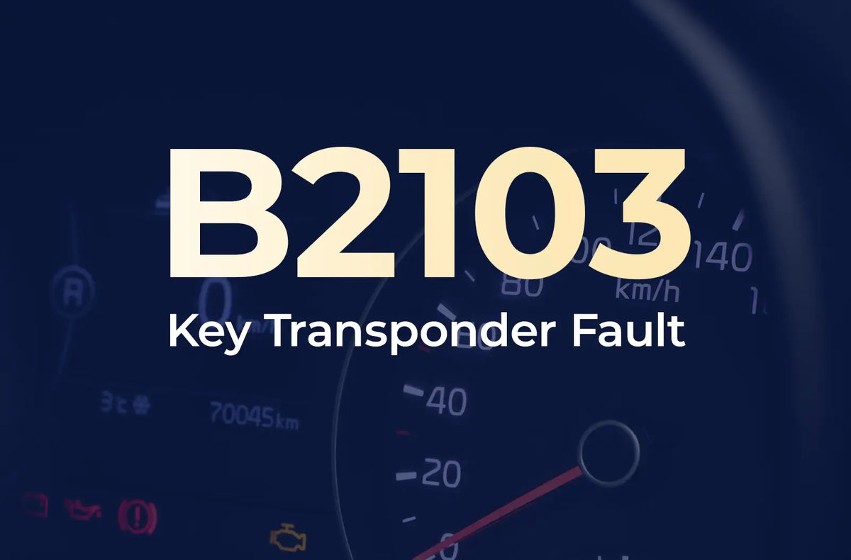 displaying the diagnostic code "B2103" and the description "Key Transponder Fault" against the blurred dark blue vehicle instrument panel.