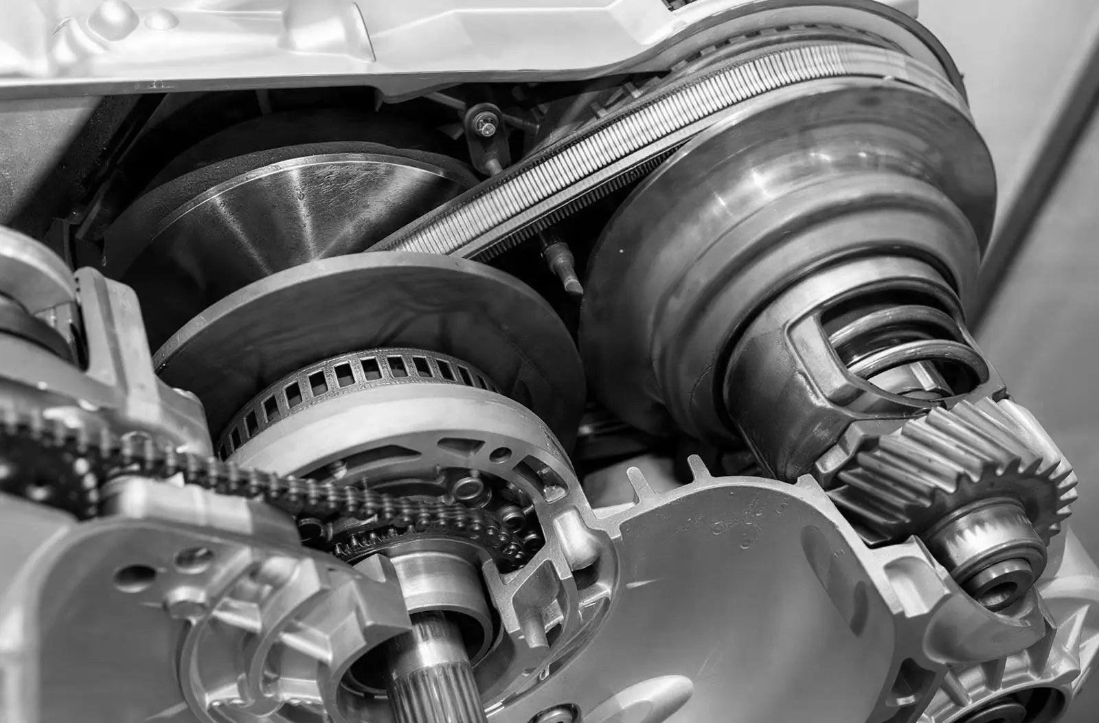A detailed technical cross-section schematic showing the inner belt, pulleys, and mechanical gears of a Continuously Variable Transmission (CVT).