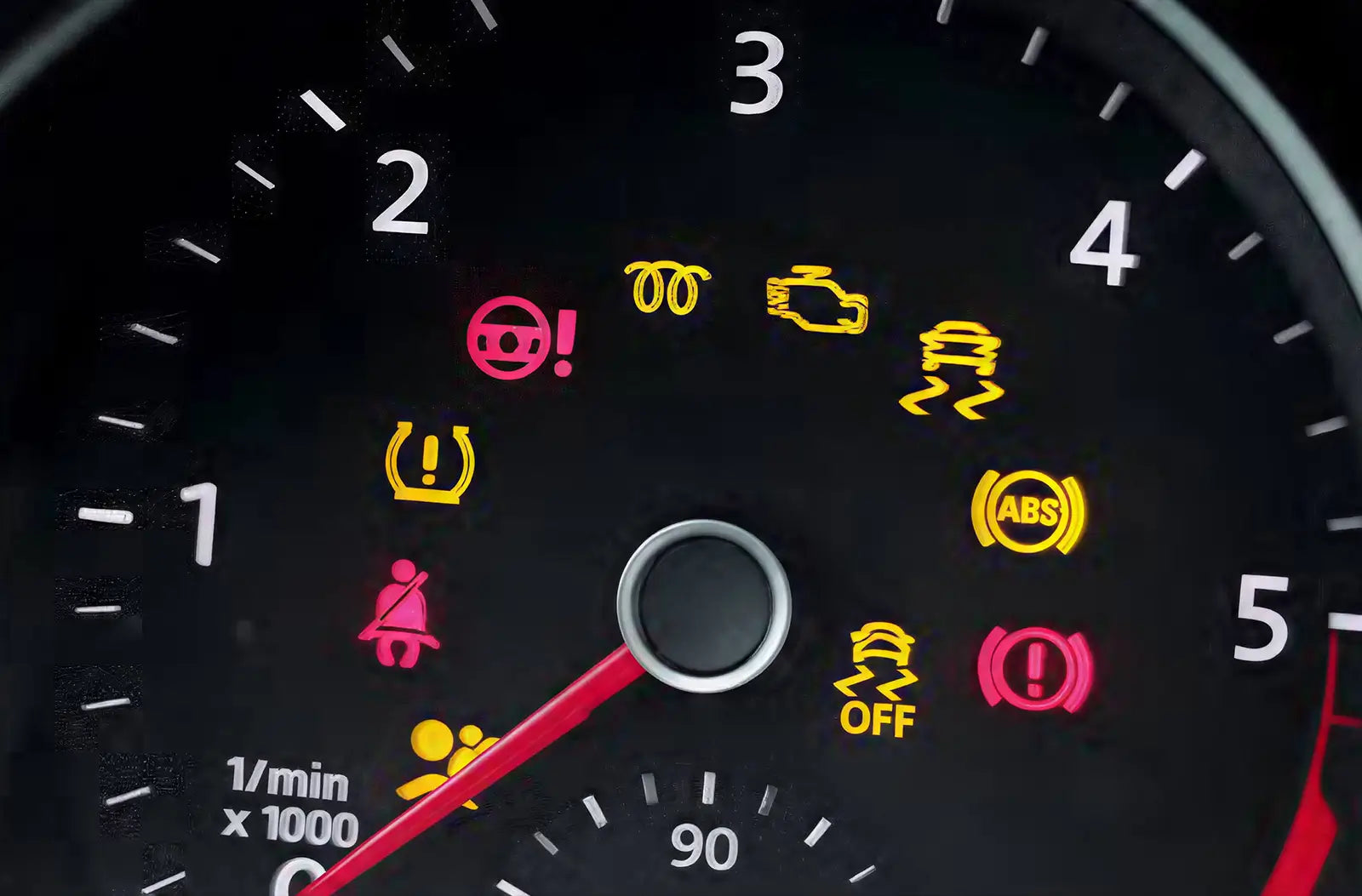 Shows a modern car's glowing digital dashboard screen illuminated at night, completely filled with various yellow and red diagnostic warning lights.